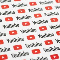 Youtube pattern printed on paper with small youtube logos and inscriptions. YouTube is Google subsidiary and American most popular video-sharing platform photo