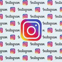 Instagram pattern printed on paper with small instagram logos and inscriptions. Instagram is American photo and video-sharing social networking service owned by Facebook