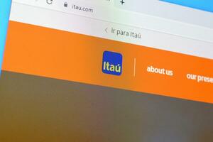 Homepage of itau website on the display of PC, url - itau.com. photo