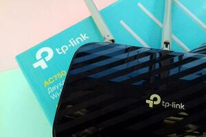 Wireless router modem tp link Archer C20 AC750 and colored cardboard box with tp-link logo photo