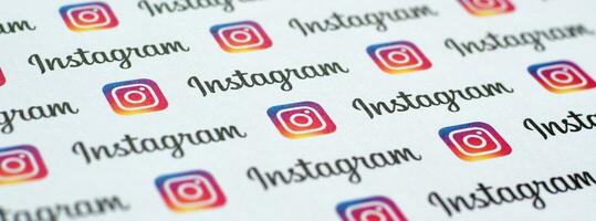 Instagram pattern printed on paper with small instagram logos and inscriptions. Instagram is American photo and video-sharing social networking service owned by Facebook