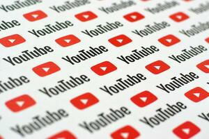 Youtube pattern printed on paper with small youtube logos and inscriptions. YouTube is Google subsidiary and American most popular video-sharing platform photo