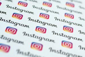 Instagram pattern printed on paper with small instagram logos and inscriptions. Instagram is American photo and video-sharing social networking service owned by Facebook