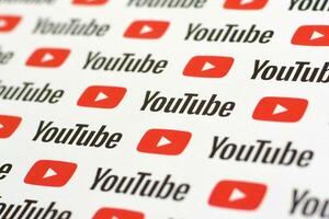 Youtube pattern printed on paper with small youtube logos and inscriptions. YouTube is Google subsidiary and American most popular video-sharing platform photo