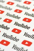 Youtube pattern printed on paper with small youtube logos and inscriptions. YouTube is Google subsidiary and American most popular video-sharing platform photo