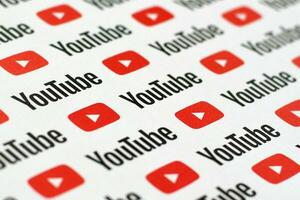 Youtube pattern printed on paper with small youtube logos and inscriptions. YouTube is Google subsidiary and American most popular video-sharing platform photo