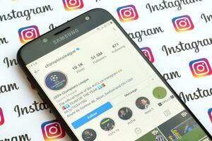 Champions League official instagram account on smartphone screen on paper instagram banner. photo