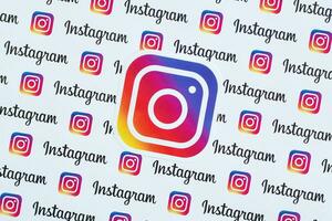 Instagram pattern printed on paper with small instagram logos and inscriptions. Instagram is American photo and video-sharing social networking service owned by Facebook