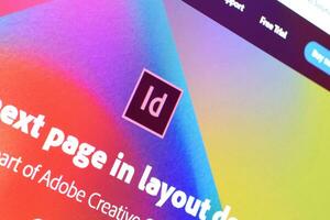 Web page of adobe indesign product on official website on the display of PC photo