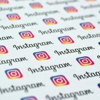 Instagram pattern printed on paper with small instagram logos and inscriptions. Instagram is American photo and video-sharing social networking service owned by Facebook