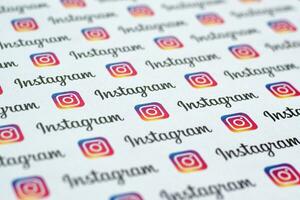 Instagram pattern printed on paper with small instagram logos and inscriptions. Instagram is American photo and video-sharing social networking service owned by Facebook