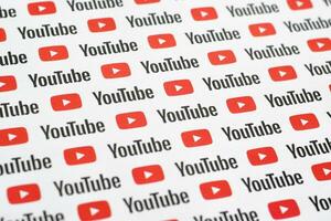 Youtube pattern printed on paper with small youtube logos and inscriptions. YouTube is Google subsidiary and American most popular video-sharing platform photo