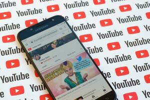 Felipe Neto official youtube channel on smartphone screen on paper youtube background. photo
