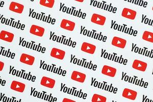 Youtube pattern printed on paper with small youtube logos and inscriptions. YouTube is Google subsidiary and American most popular video-sharing platform photo