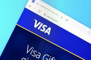 Homepage of visa website on the display of PC, url - visa.com. photo