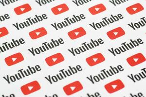 Youtube pattern printed on paper with small youtube logos and inscriptions. YouTube is Google subsidiary and American most popular video-sharing platform photo