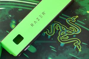 Razer Goliathus Speed Gaming green mouse pad and box with logo. Razer global gaming hardware manufacturing company, as well as an esports and financial services photo