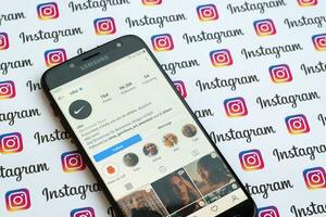 Nike official instagram account on smartphone screen on paper instagram banner. photo