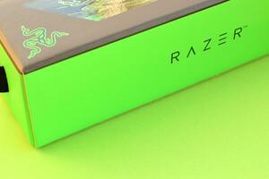 Razer Goliathus Speed Gaming green mouse pad and box with logo. Razer global gaming hardware manufacturing company, as well as an esports and financial services photo