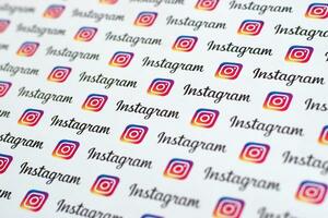 Instagram pattern printed on paper with small instagram logos and inscriptions. Instagram is American photo and video-sharing social networking service owned by Facebook