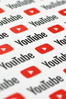 Youtube pattern printed on paper with small youtube logos and inscriptions. YouTube is Google subsidiary and American most popular video-sharing platform photo
