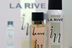 La rive IN woman deodorant and perfume bottles on prefume box background. LA RIVE S.A. is one of the leading producers of perfumes and perfumed waters in Europe photo