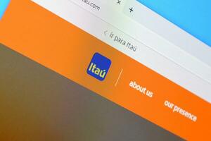 Homepage of itau website on the display of PC, url - itau.com. photo