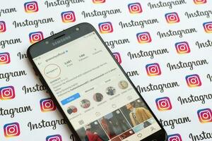 Givenchy official instagram account on smartphone screen on paper instagram banner. photo