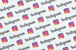 Instagram pattern printed on paper with small instagram logos and inscriptions. Instagram is American photo and video-sharing social networking service owned by Facebook