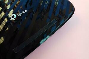 New tp-link logo on wireless router modem tp link Archer C20 AC750 reflective surface photo