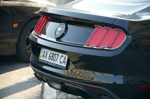 KHARKOV, UKRAINE - OCTOBER 20, 2019 Black 2015 Ford Mustang 50 Year Limited Edition rear view outdoors photo