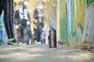 KHARKOV, UKRAINE - OCTOBER 19, 2019 Montana mtn black nc formula used spray can for graffiti painting outdoors in autumn leafs and artist in painting process photo