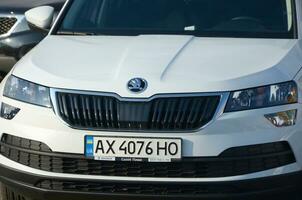 KHARKOV, UKRAINE - OCTOBER 20, 2019 Skoda Karoq car logo and front part. Skoda is a Czech automobile manufacturer founded in 1895 photo