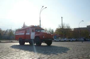 KHARKOV, UKRAINE - OCTOBER 25, 2019 Fire rescue truck from post soviet era parks on main Kharkiv city freedom square photo