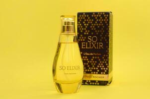 KHARKOV, UKRAINE - OCTOBER 21, 2019 Bottle of So Elixir perfume by Yves Rocher on bright yellow color background photo