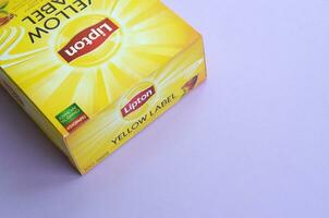 Lipton Yellow Label black tea pack on pastel lilac surface close up. Lipton is a world famous brand of tea photo