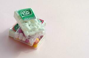 Many Tic Tac Candy packages close up. Tic tac is popular due its minty fresh taste and easy to carry. Hard mints produced by Ferrero since 1968 photo