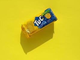 Tuc snack pack on bright yellow flat background photo