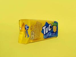 Tuc snack pack on bright yellow flat background photo