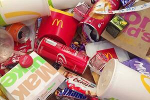 Many used food wrappings and drink cans by random food manufacturing famous brands. Recycled trash of treats and soda drinks photo