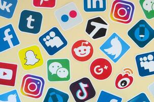 Many paper icons with logo of most popular social networks and smartphone apps for chat and conversations online photo