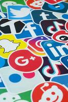 Many paper icons with logo of most popular social networks and smartphone apps for chat and conversations online photo