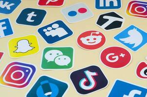 Many paper icons with logo of most popular social networks and smartphone apps for chat and conversations online photo