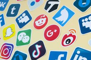 Many paper icons with logo of most popular social networks and smartphone apps for chat and conversations online photo