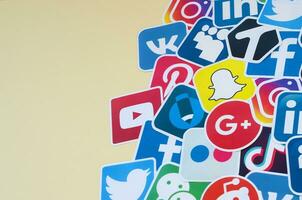 Many paper icons with logo of most popular social networks and smartphone apps for chat and conversations online photo