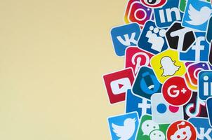 Many paper icons with logo of most popular social networks and smartphone apps for chat and conversations online photo
