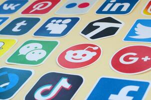 Many paper icons with logo of most popular social networks and smartphone apps for chat and conversations online photo