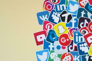 Many paper icons with logo of most popular social networks and smartphone apps for chat and conversations online photo