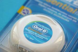 KYIV, UKRAINE - JULY 7, 2023 Oral-B Essentail Floss. Waxed dental floss in round case photo