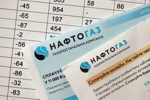 KYIV, UKRAINE - JULY 7, 2023 Naftogaz utility bill document with ukrainian hryvnias money photo